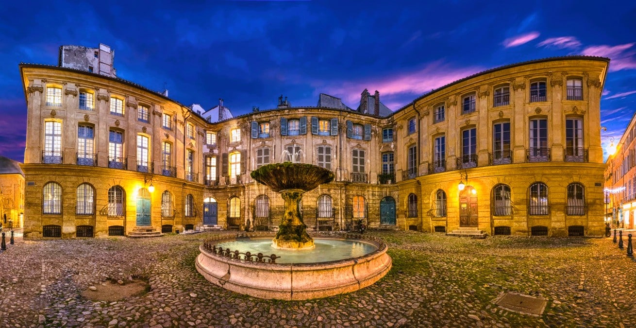 Fontaine de la place d’Albertas illuminée à la tombée de la nuit, devant les façades uniformes et les balcons en fer forgé des hôtels particuliers du XVIIIe siècle, place protégée au titre des monuments historiques au cœur du centre historique d’Aix-en-Provence, dans le département des Bouches-du-Rhône, en région Provence-Alpes-Côte d’Azur. Fontaine de la place d’Albertas illuminée à la tombée de la nuit, devant les façades uniformes et les balcons en fer forgé des hôtels particuliers du XVIIIe siècle, place protégée au titre des monuments historiques au cœur du centre historique d’Aix-en-Provence, dans le département des Bouches-du-Rhône, en région Provence-Alpes-Côte d’Azur.